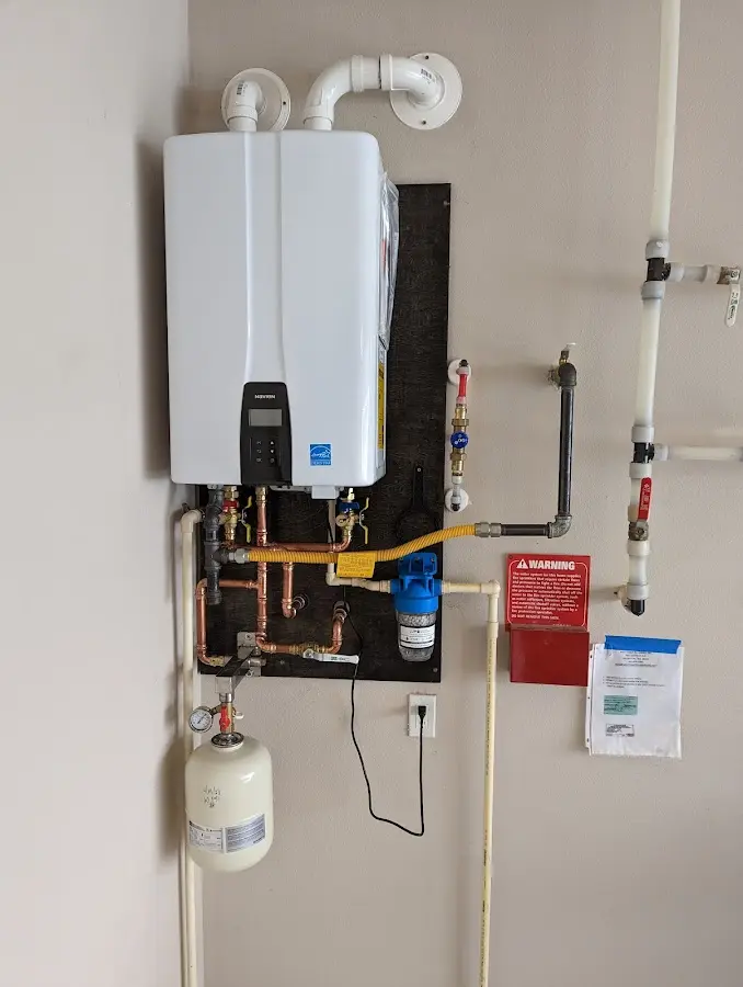 Professional plumber installing copper piping in a Murphy home